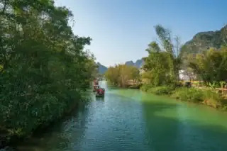 Łodzie na rzece Yulong w Yangshuo otoczonej górami krasowymi – rowerowa wyprawa przez Chiny